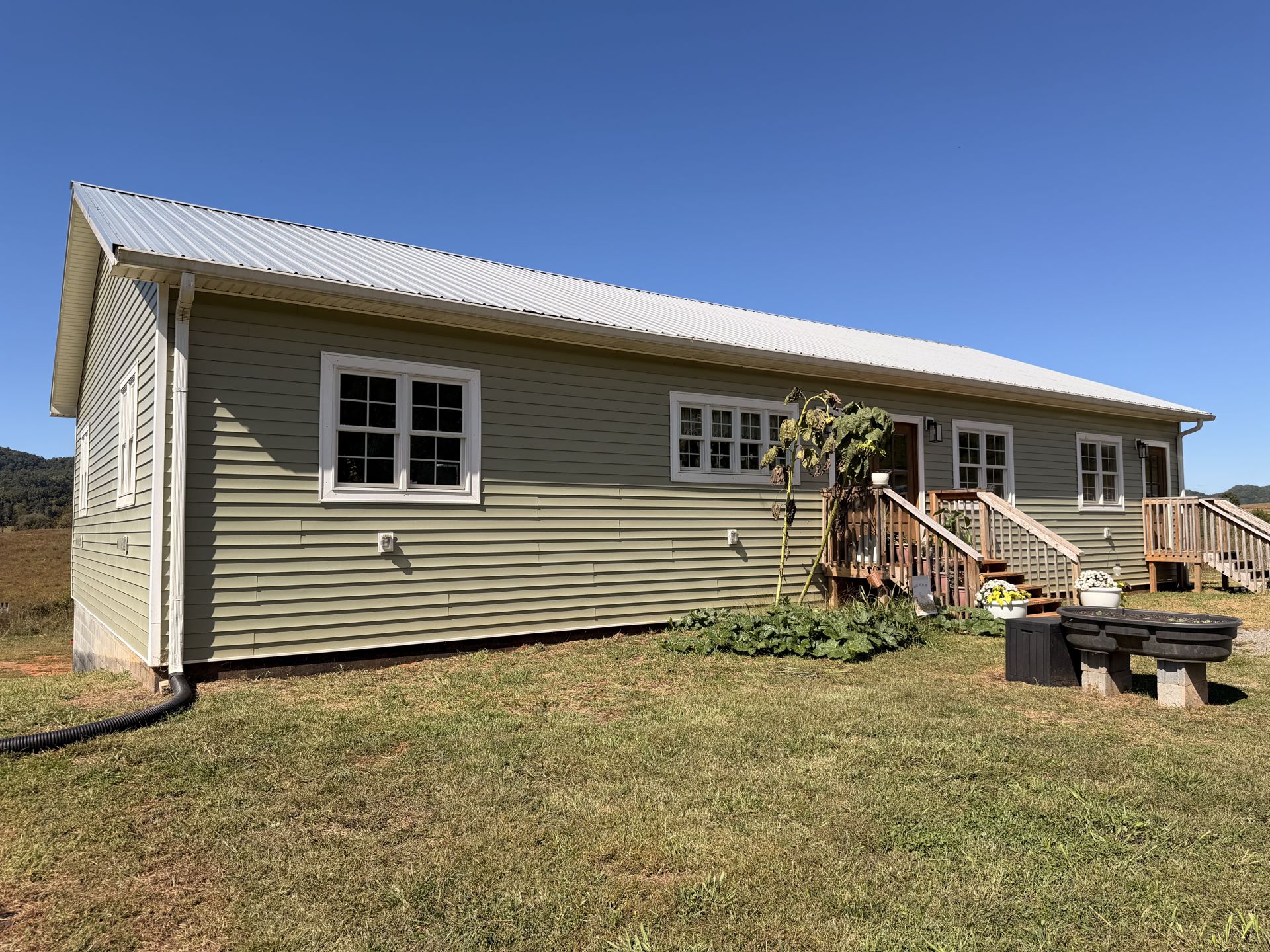 2025-built sage green farmhouse with metal roof